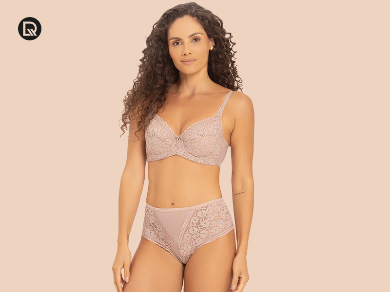 Modelo vestindo conjunto de lingerie em cor nude.